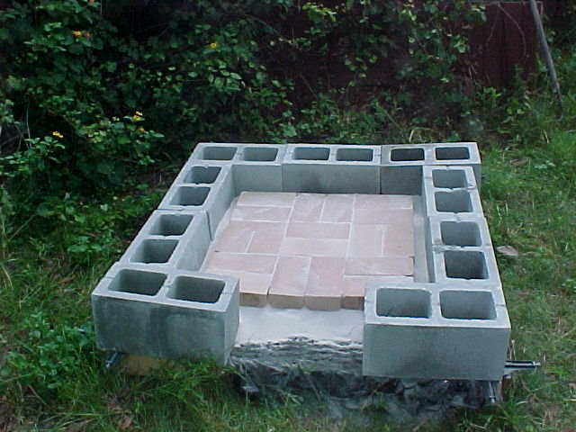 first course of cinder blocks down and first course of fire bricks for base