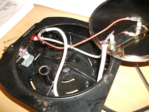 the interior of the electric hotplate showing the rewiring of power leads