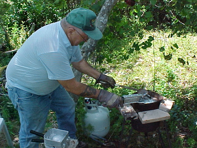 Generations of lead casters, this is Dad pouring some Do-It molds for egg sinkers